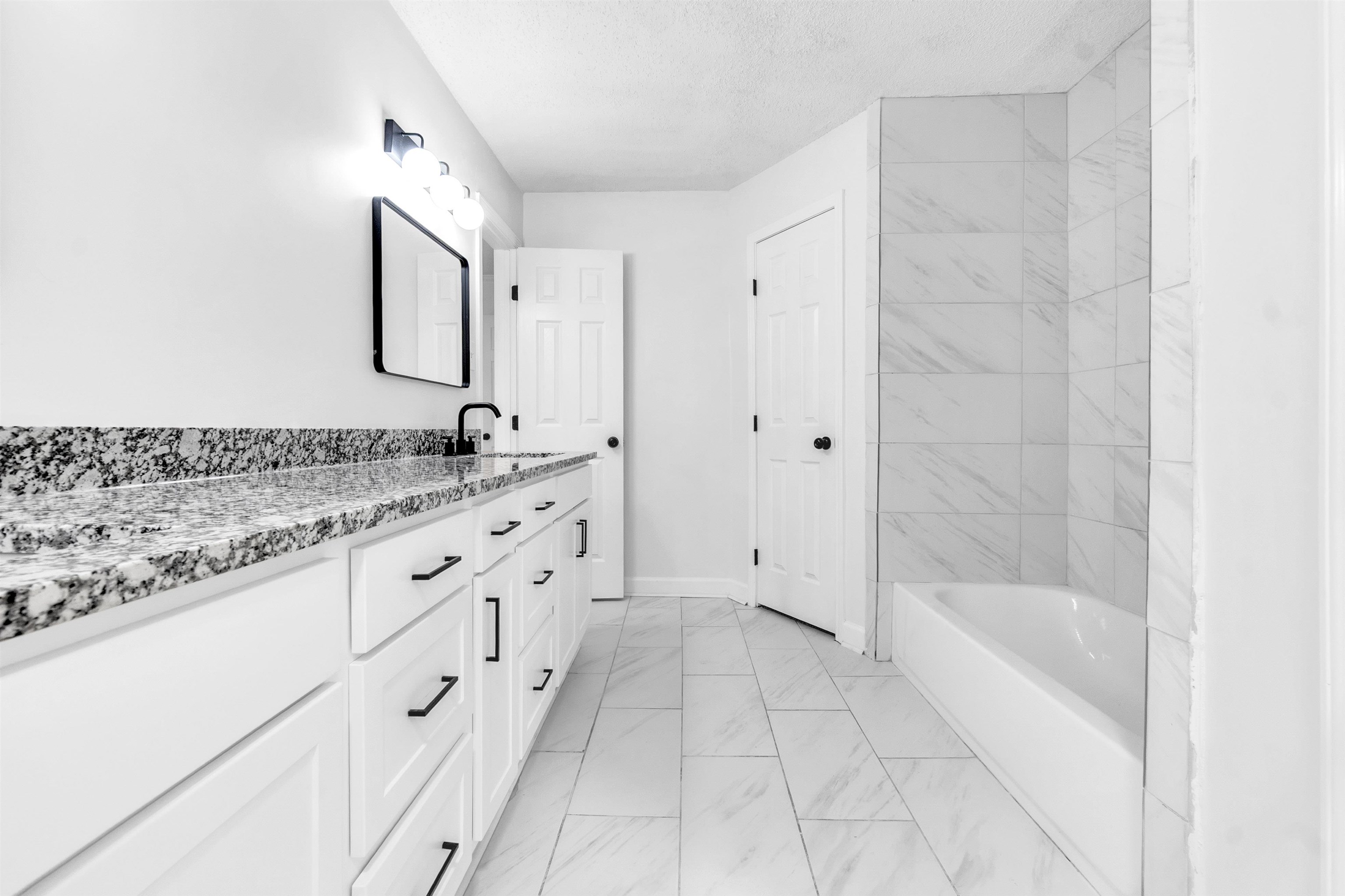 488 West Regis Place Memphis, TN 38018 - Photo 10 of 17 Full bath with vanity, light marble finish floors, a textured ceiling, and shower / tub combination