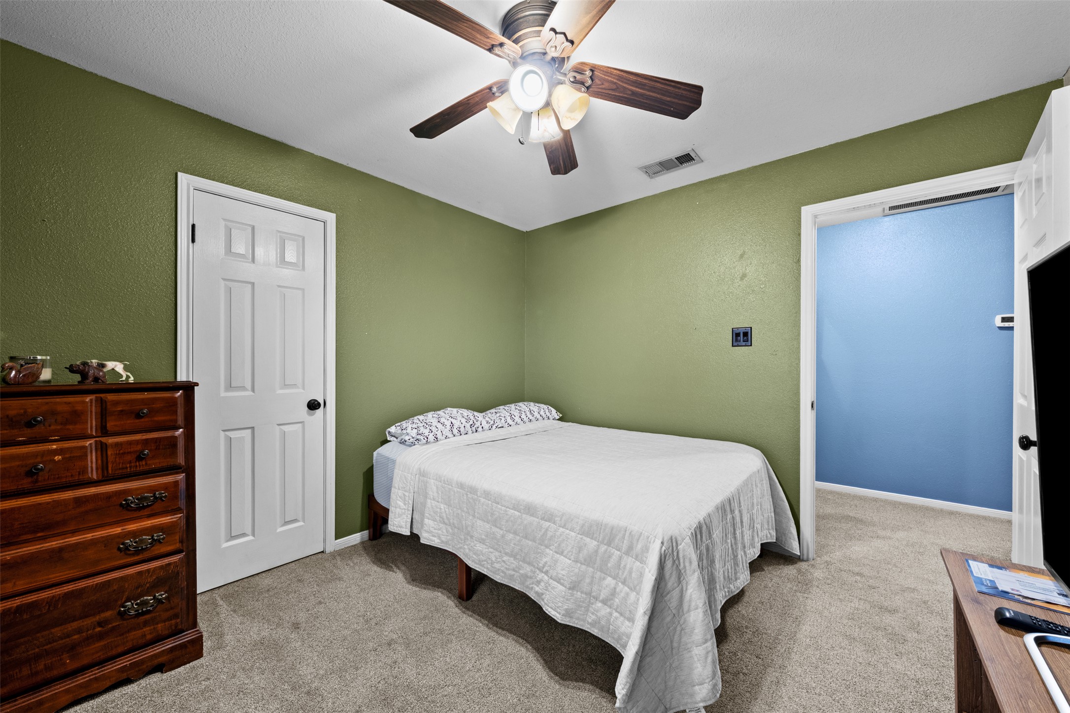 1512 Panther Loop Pflugerville, TX 78660 - Photo 12 of 40 A comfortable bedroom features carpet flooring and a ceiling fan, offering a serene retreat.
