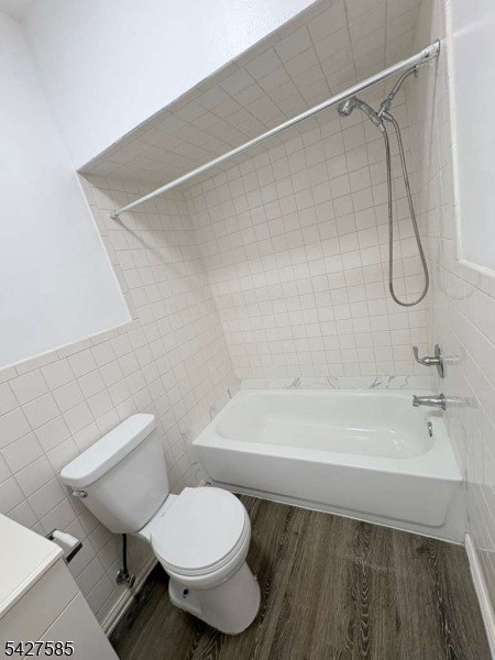 70 Main Street Garfield, NJ 07026 - Photo 2 of 9 a bathroom with a toilet and a bathtub