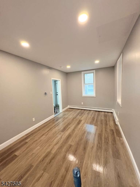 70 Main Street Garfield, NJ 07026 - Photo 5 of 9 an empty room with wooden floor and windows