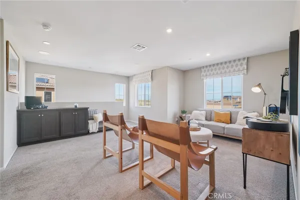 a living room with furniture a large window and a table