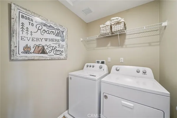 a view of storage and utility room with washer and dryer