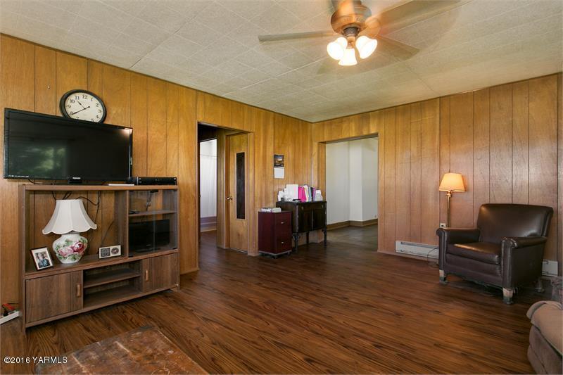 200 East Evans Road Wapato, WA 98951 - Photo 11 of 19 a living room with furniture and a flat screen tv