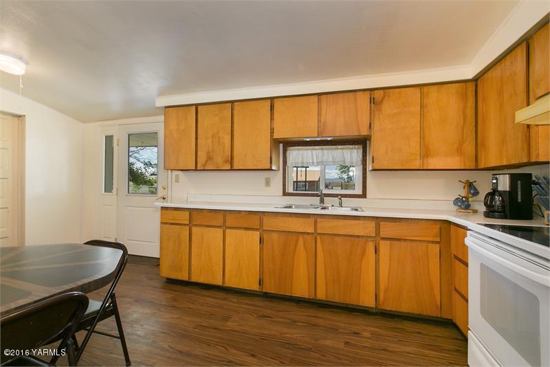 200 East Evans Road Wapato, WA 98951 - Photo 13 of 19 a kitchen with stainless steel appliances granite countertop a sink and cabinets