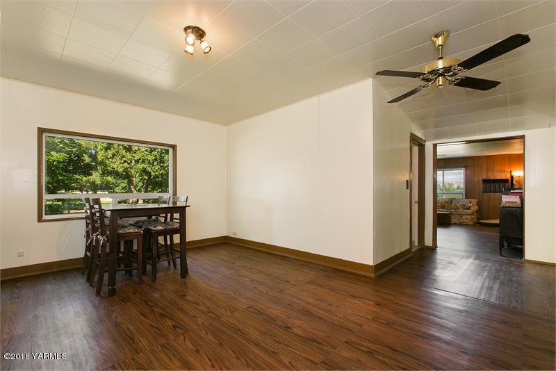 200 East Evans Road Wapato, WA 98951 - Photo 15 of 19 a view of a dining room with furniture window and wooden floor