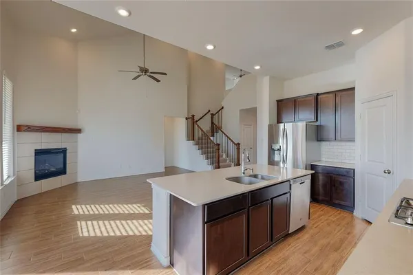 a kitchen with stainless steel appliances granite countertop a sink a stove and a refrigerator