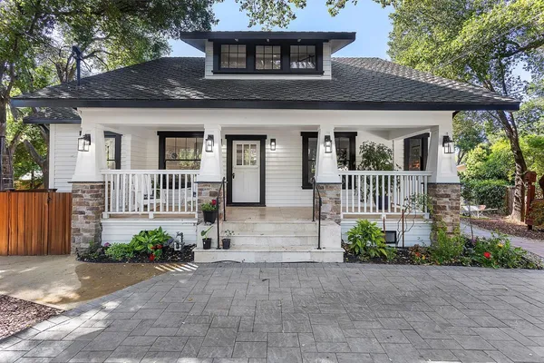 a front view of a house with a garden