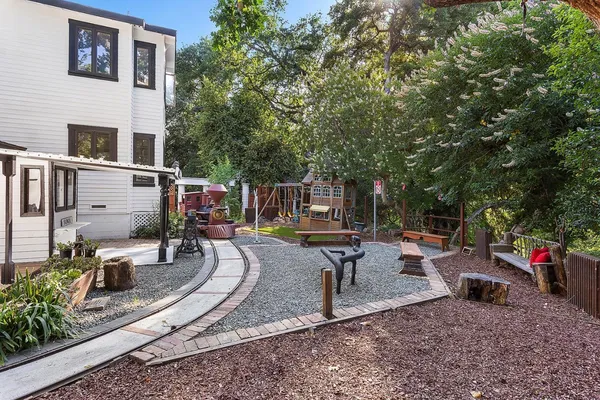 a view of backyard with swimming pool and sitting area