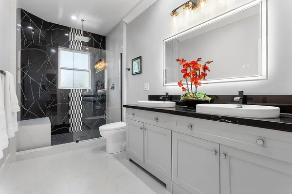 a bathroom with a sink a toilet and shower