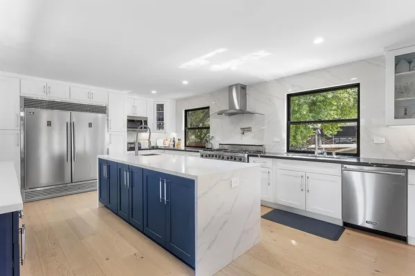 a kitchen with stainless steel appliances granite countertop a refrigerator sink and cabinets