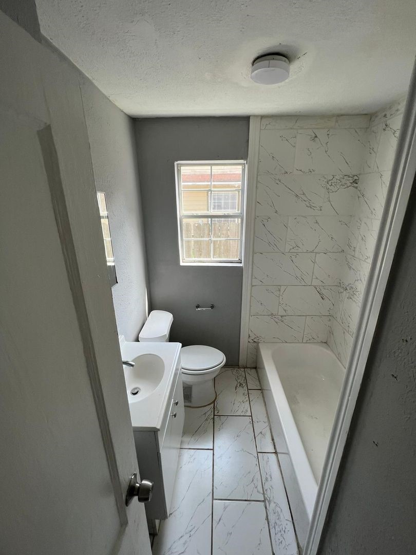 3012 Live Oak Street Houston, TX 77004 - Photo 6 of 6 a bathroom with a toilet a sink and a bathtub