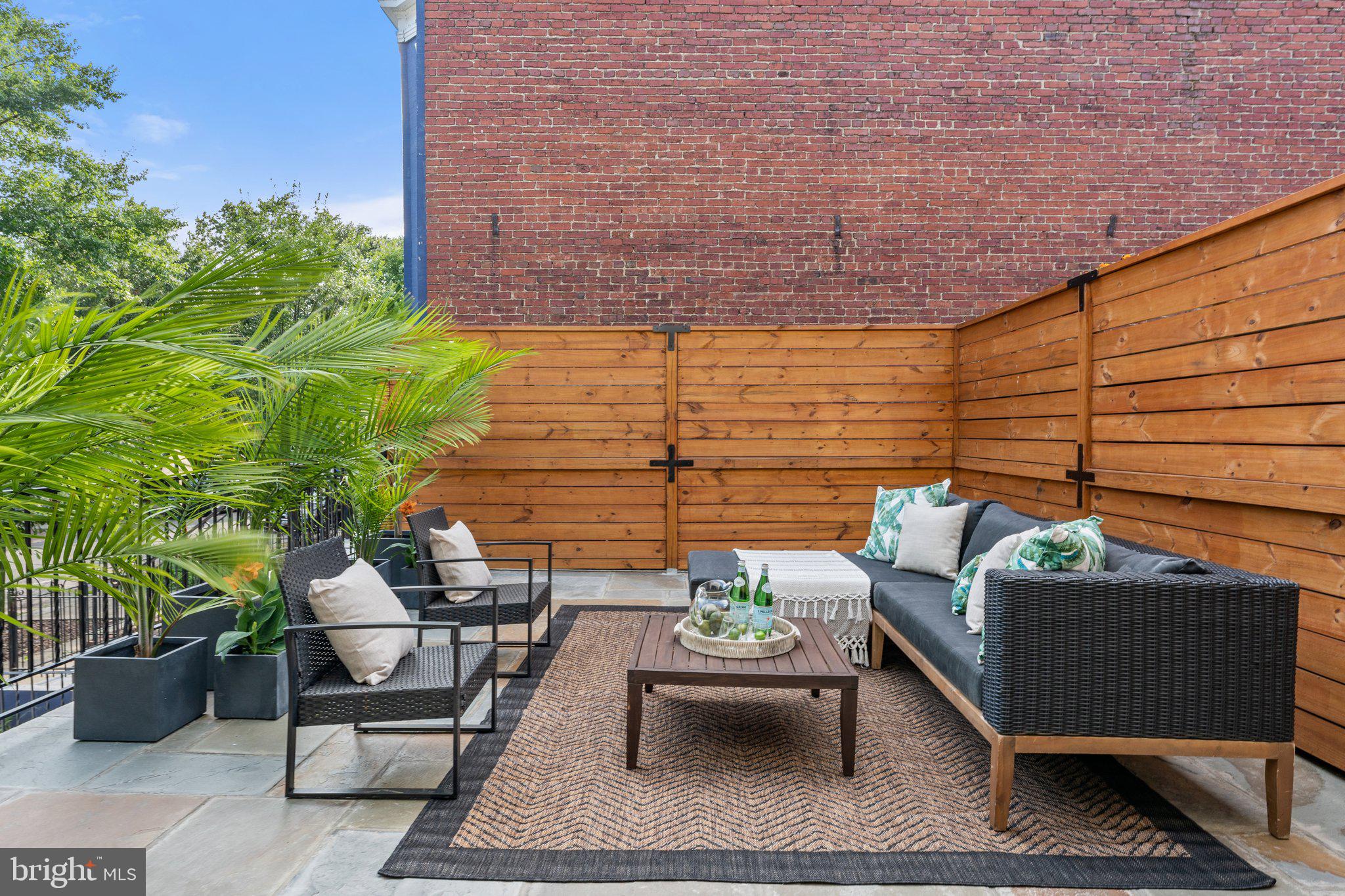 900 8th Street Northeast Washington, DC 20002 - Photo 16 of 50 a view of a patio with couches and a potted plant on a table