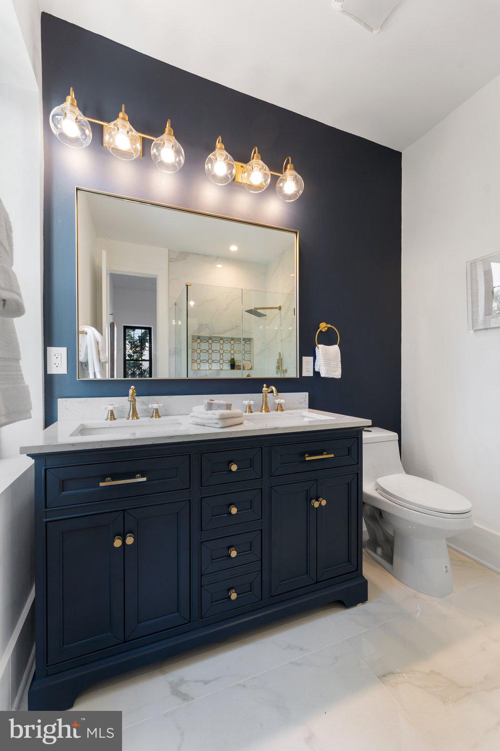 900 8th Street Northeast Washington, DC 20002 - Photo 27 of 50 a bathroom with a sink and a large mirror