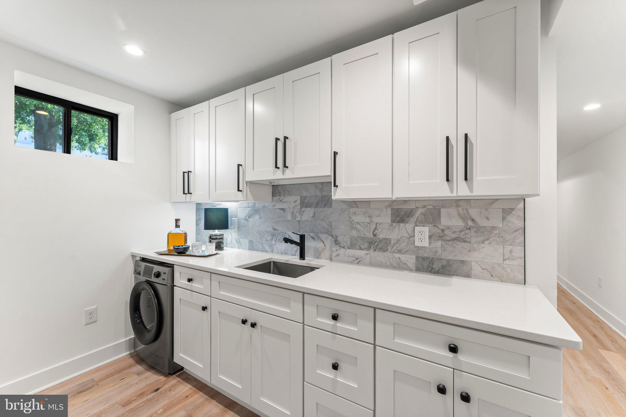 900 8th Street Northeast Washington, DC 20002 - Photo 41 of 50 a kitchen with white cabinets and sink