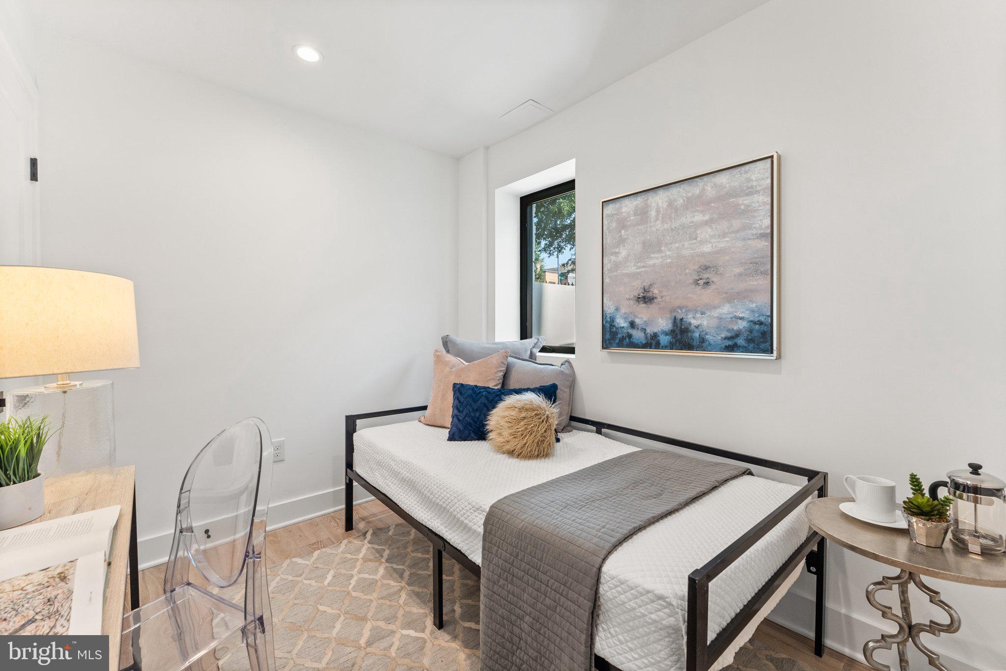 900 8th Street Northeast Washington, DC 20002 - Photo 43 of 50 a bedroom with a bed and chair