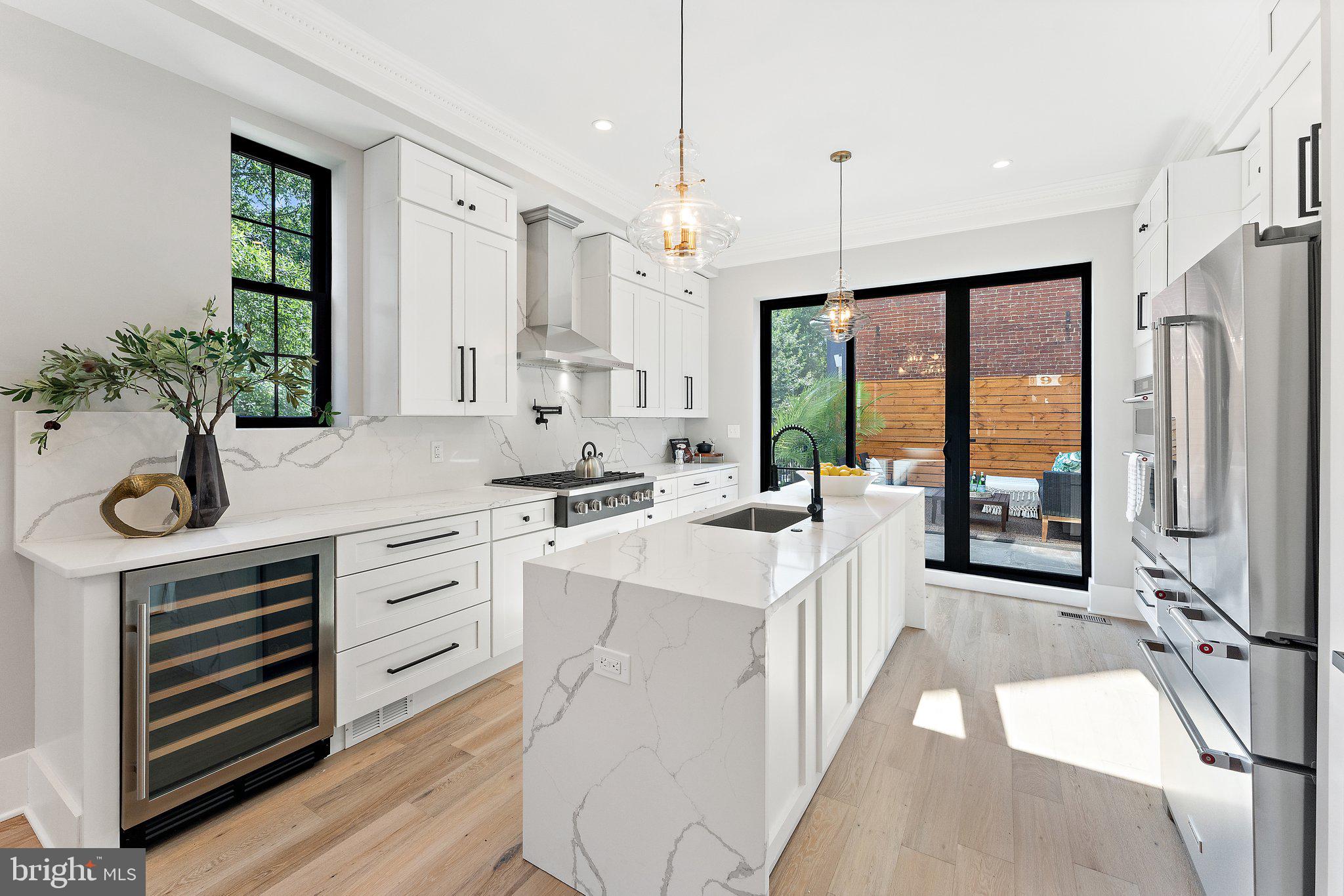 900 8th Street Northeast Washington, DC 20002 - Photo 9 of 50 a kitchen with white cabinets and white appliances