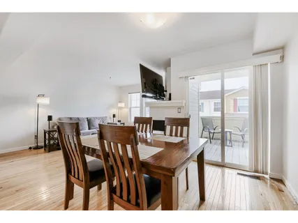 a dining room with furniture and wooden floor