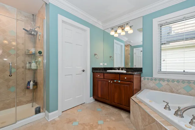 a bathroom with a tub sink and mirror