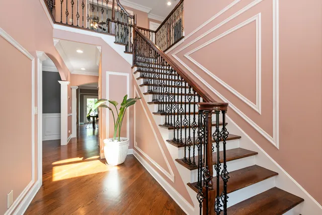 a view of entryway and hall with wooden floor