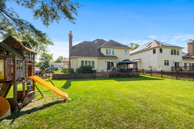 a view of a house with swimming pool and a yard