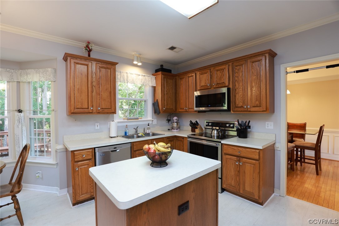 13906 Sagebrook Road Midlothian, VA 23112 - Photo 11 of 50 a kitchen with a sink a stove top oven a kitchen island a dining table and chairs
