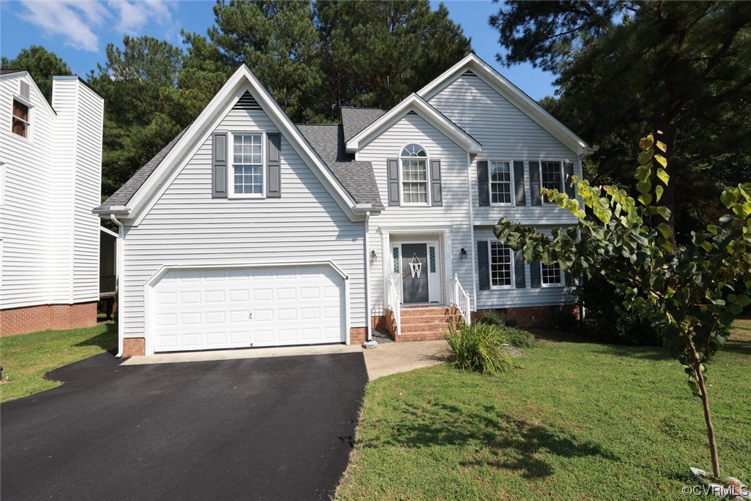 13906 Sagebrook Road Midlothian, VA 23112 - Photo 2 of 50 a front view of a house with a garden and yard