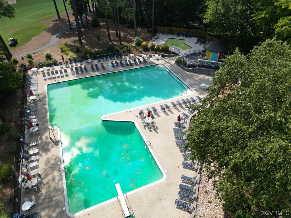 13906 Sagebrook Road Midlothian, VA 23112 - Photo 44 of 50 a view of a swimming pool with lawn chairs under an umbrella