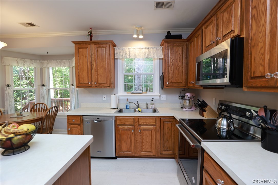 13906 Sagebrook Road Midlothian, VA 23112 - Photo 10 of 50 a kitchen with a sink a stove and wooden cabinets