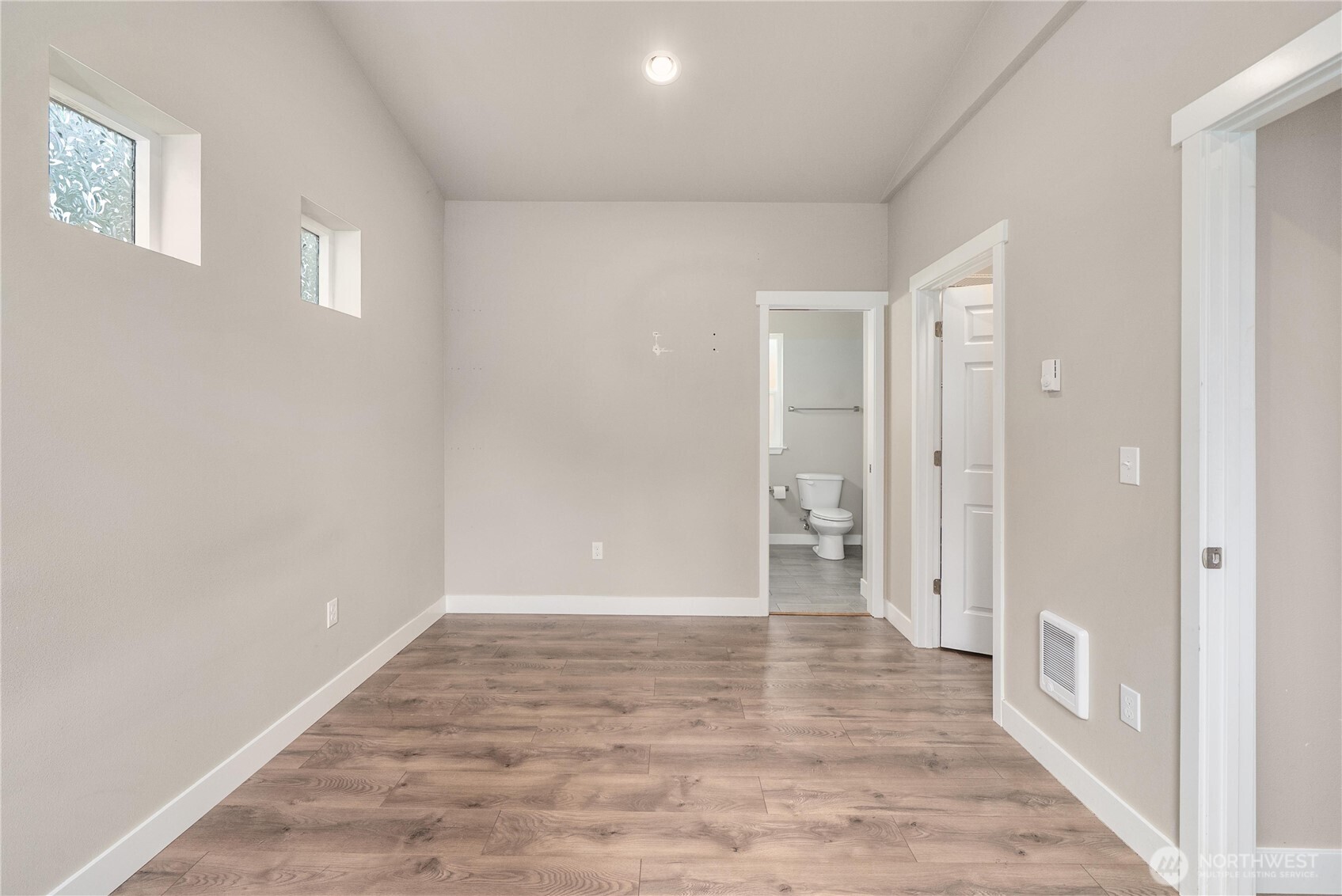 61 East Brady Loop Allyn, WA 98524 - Photo 13 of 27 a view of an empty room with wooden floor