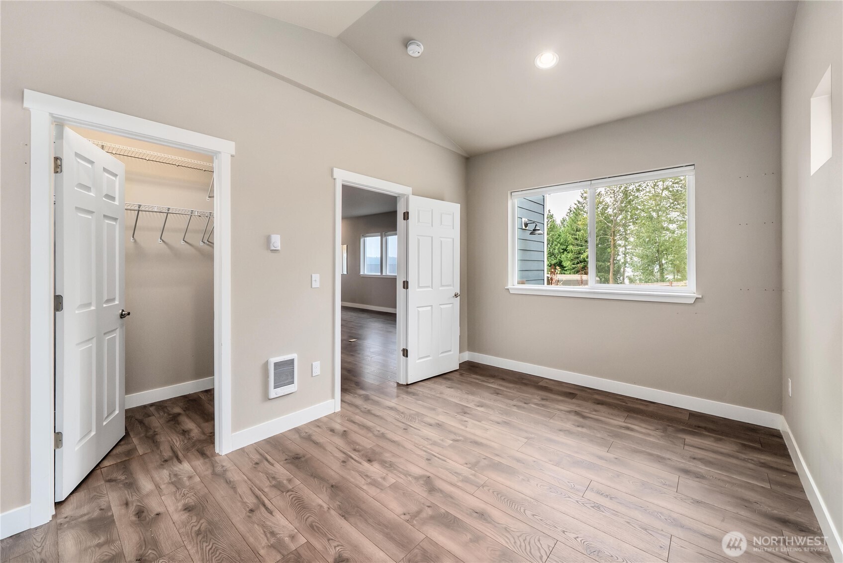 61 East Brady Loop Allyn, WA 98524 - Photo 14 of 27 a view of an empty room with wooden floor and a window