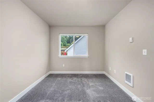 a view of house with backyard and wooden fence