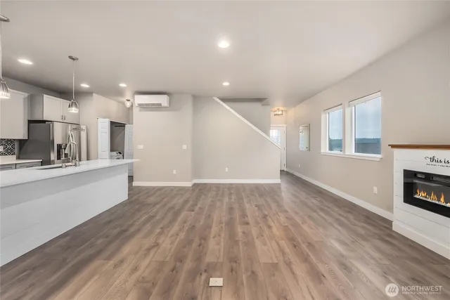 a view of kitchen with furniture and wooden floor