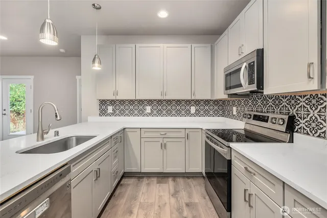 a kitchen that has a sink and a stove