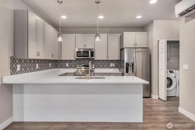 an empty room with windows and a fireplace