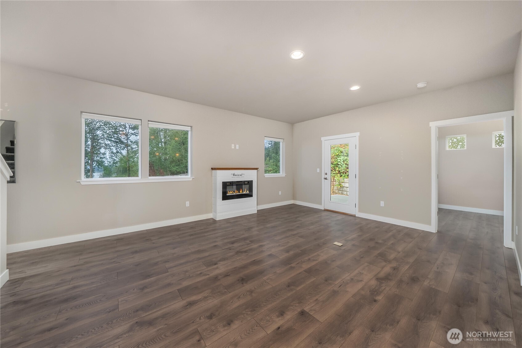61 East Brady Loop Allyn, WA 98524 - Photo 9 of 27 an empty room with windows and a fireplace