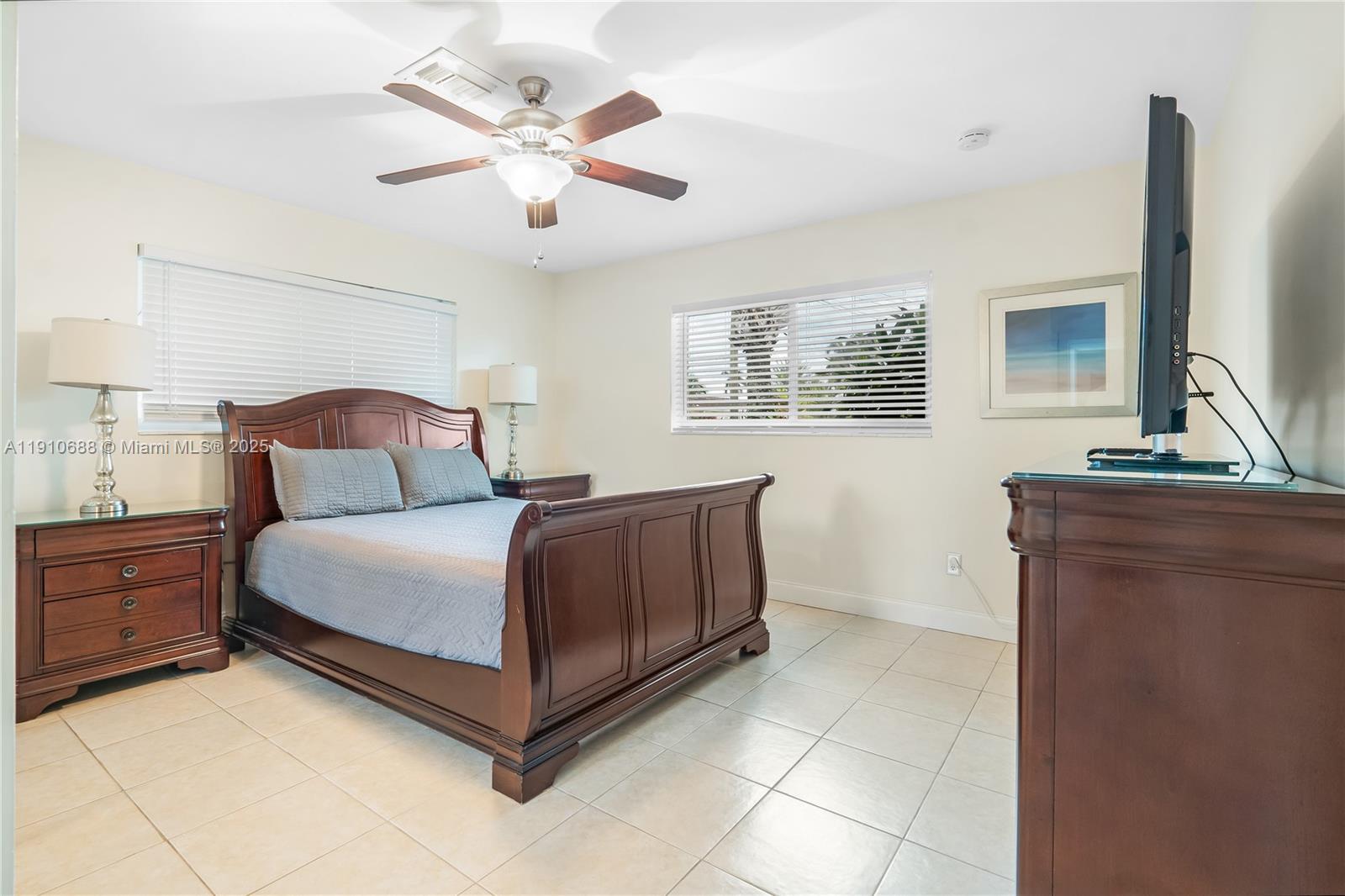281 Southeast 3rd Court Pompano Beach, FL 33060 - Photo 21 of 39 a bedroom with a large bed and a chandelier
