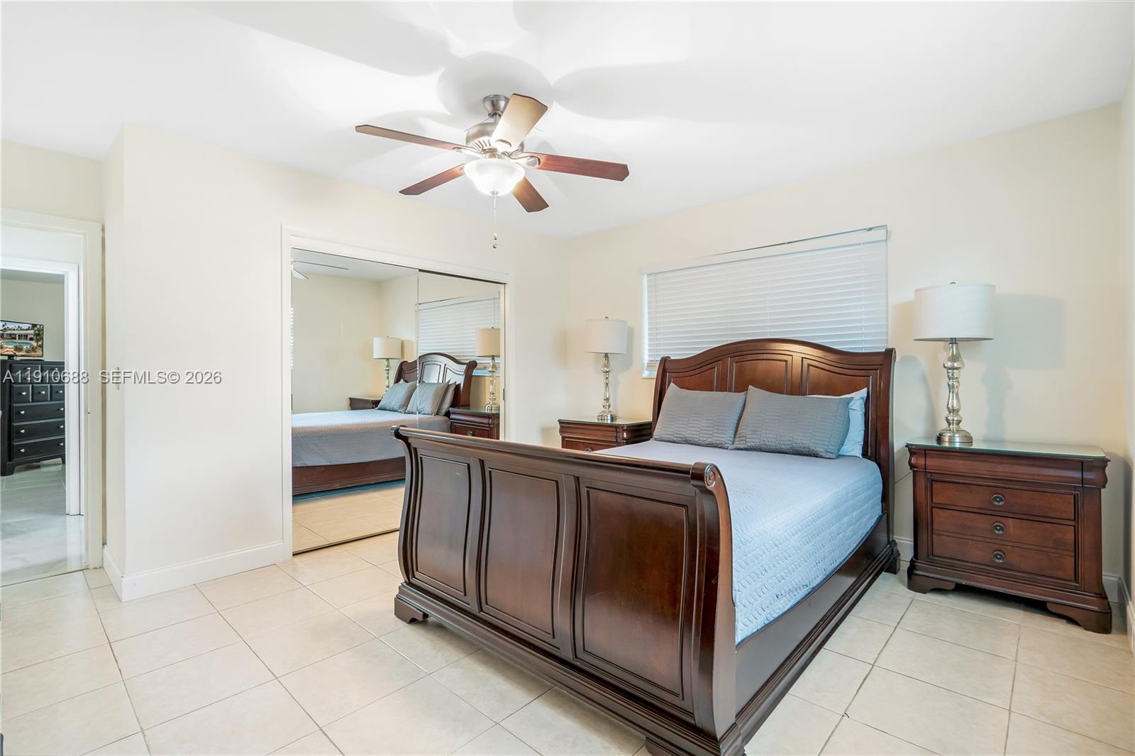 281 Southeast 3rd Court Pompano Beach, FL 33060 - Photo 22 of 39 a bedroom with a bed and a chandelier