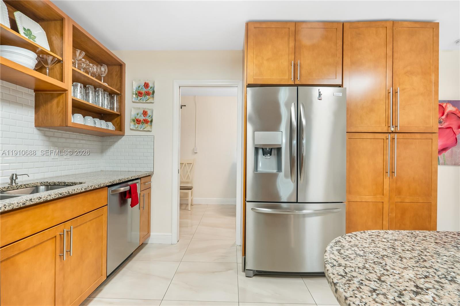 281 Southeast 3rd Court Pompano Beach, FL 33060 - Photo 30 of 39 a kitchen with stainless steel appliances granite countertop a refrigerator and a sink