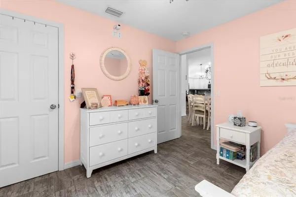 a living room with furniture a mirror and a dresser