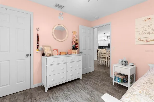a living room with furniture a mirror and a dresser