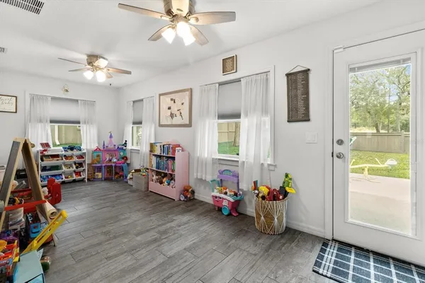 a view of a livingroom with workspace and a window