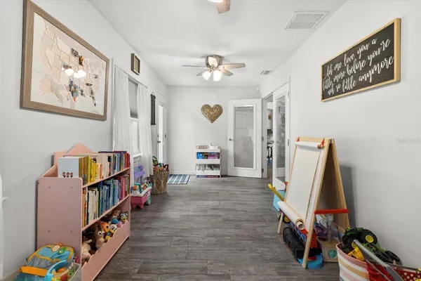 a living room with furniture and a book shelf