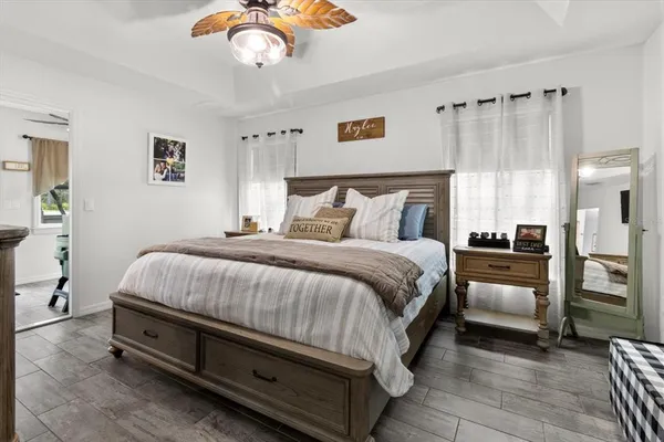 a spacious bedroom with a bed and a chandelier