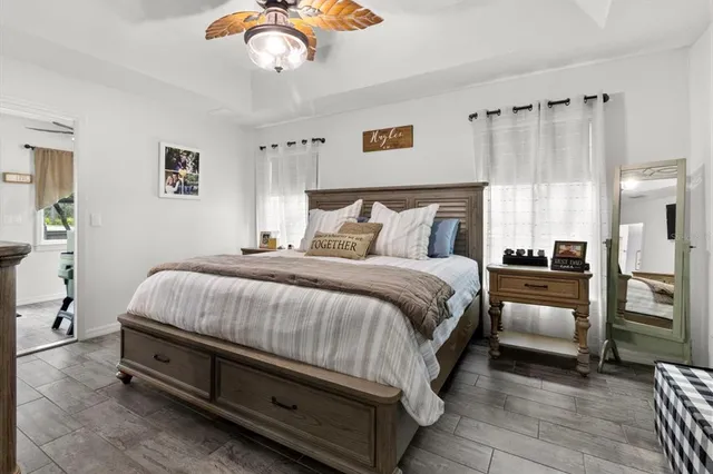 a spacious bedroom with a bed and a chandelier