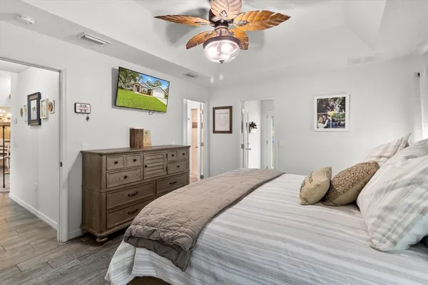 a bedroom with a bed and a chandelier