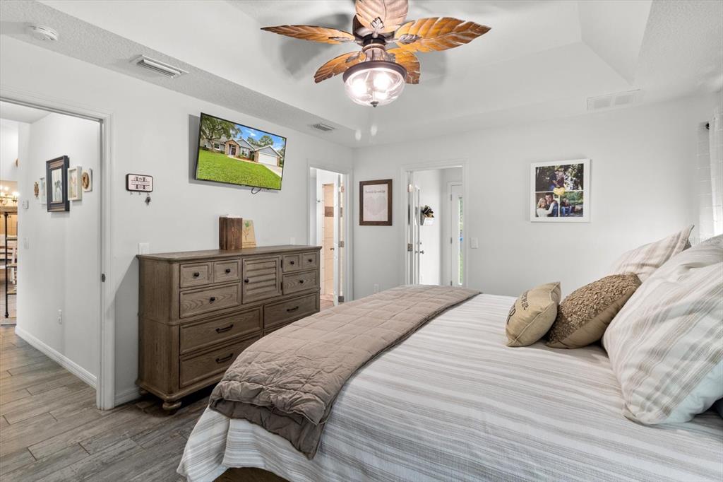 5317 West Tortuga Loop Lecanto, FL 34461 - Photo 24 of 37 a bedroom with a bed and a chandelier