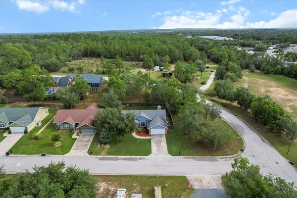 an aerial view of residential houses with outdoor space and street view