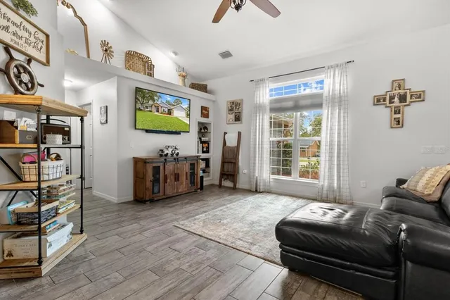 a living room with furniture and a flat screen tv