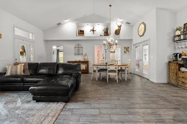 a living room with furniture a large window and a clock