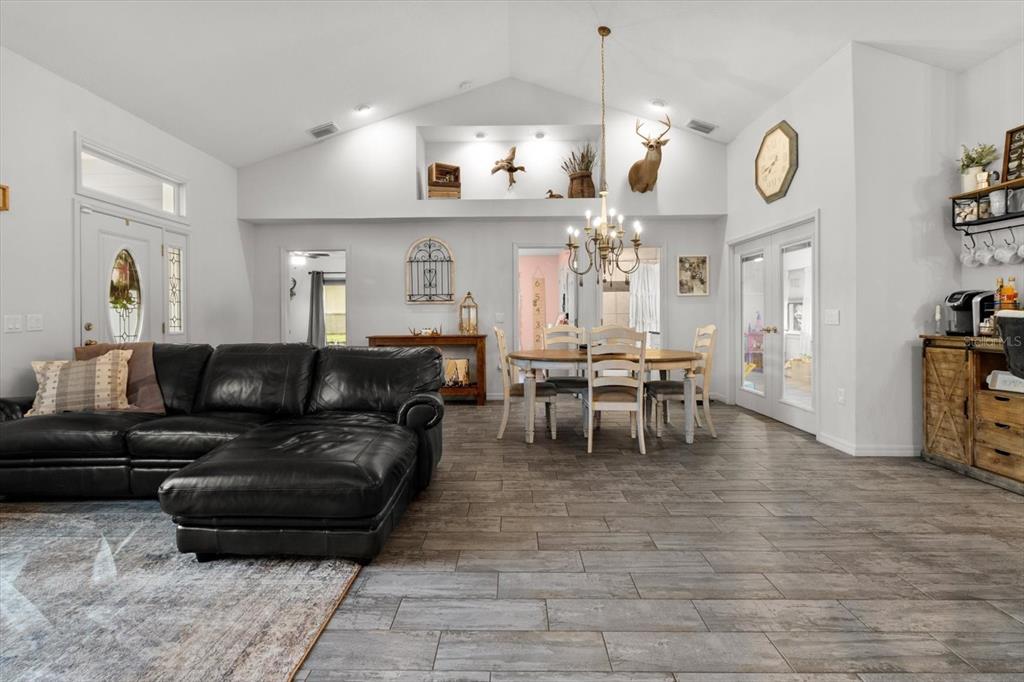 5317 West Tortuga Loop Lecanto, FL 34461 - Photo 8 of 37 a living room with furniture a large window and a clock